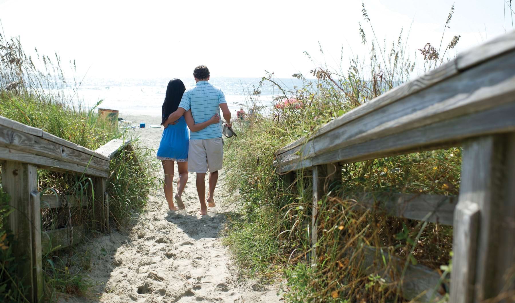 Lifestyle image of couple walking on the beach Lifestyle image of couple walking on the beach